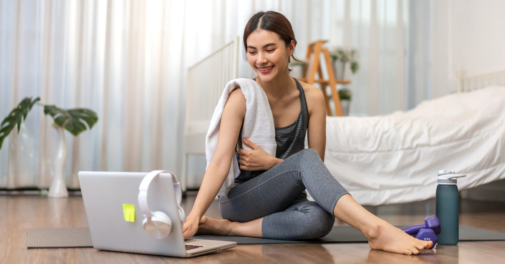 Woman using a laptop at home, A Plus Health case study