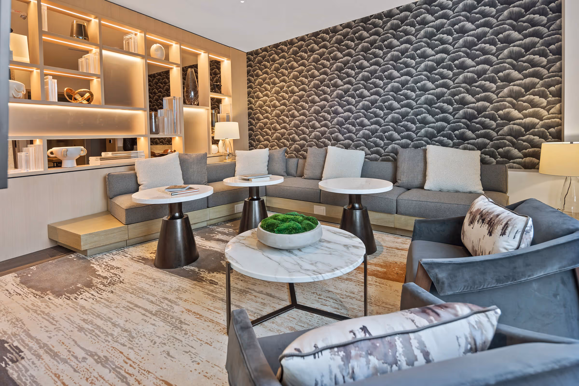Floor-to-ceiling bookcase behind comfy seating in the Exclusive Owners' Lounge