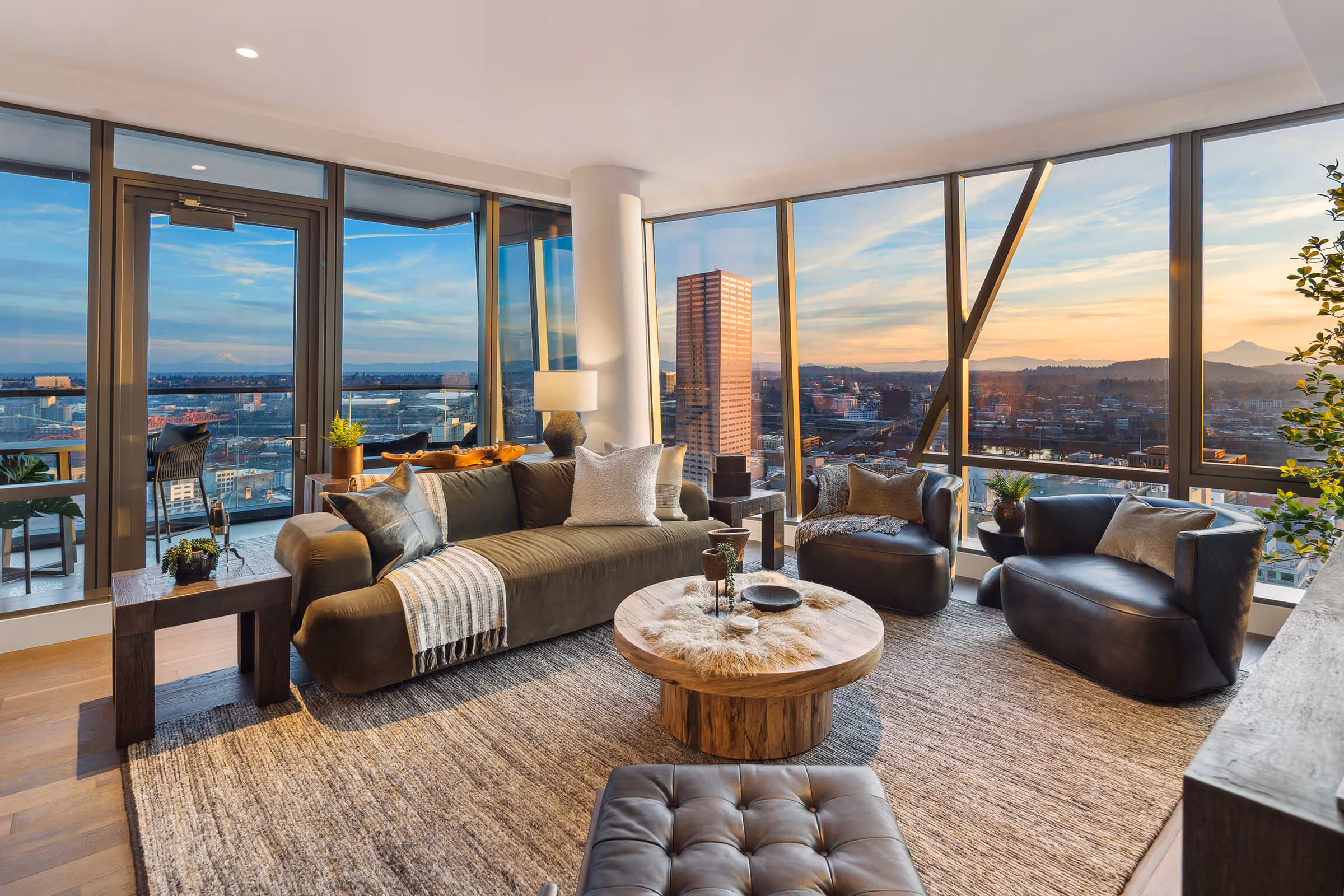 Colors of the sunrise paint Mount St. Helens and Mt. Hood seen through the Residence living area windows