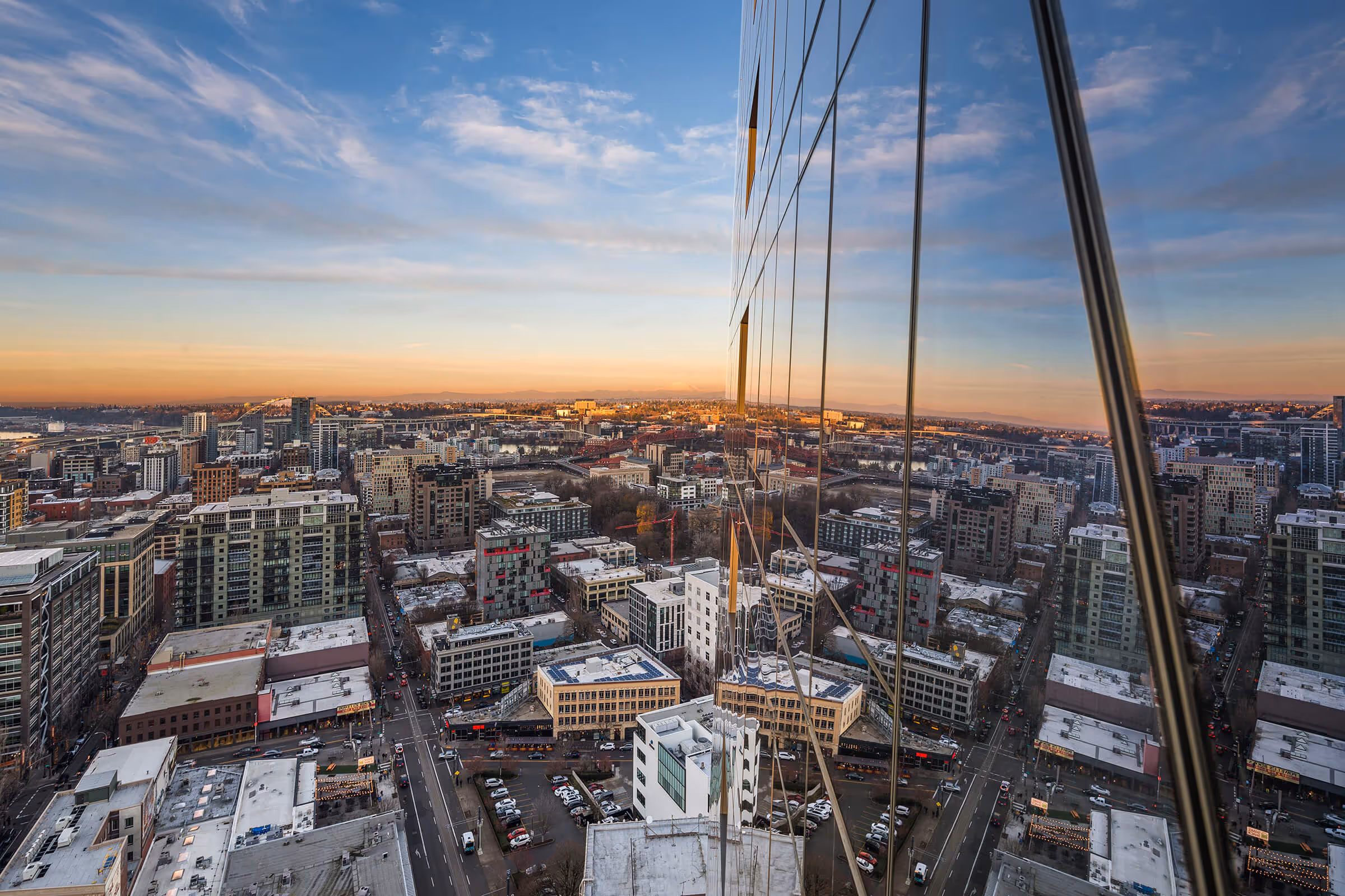 Sunset colors reflecting off the glass facade as seen from the balcony of Forest Park Executive Suite, Residence 04