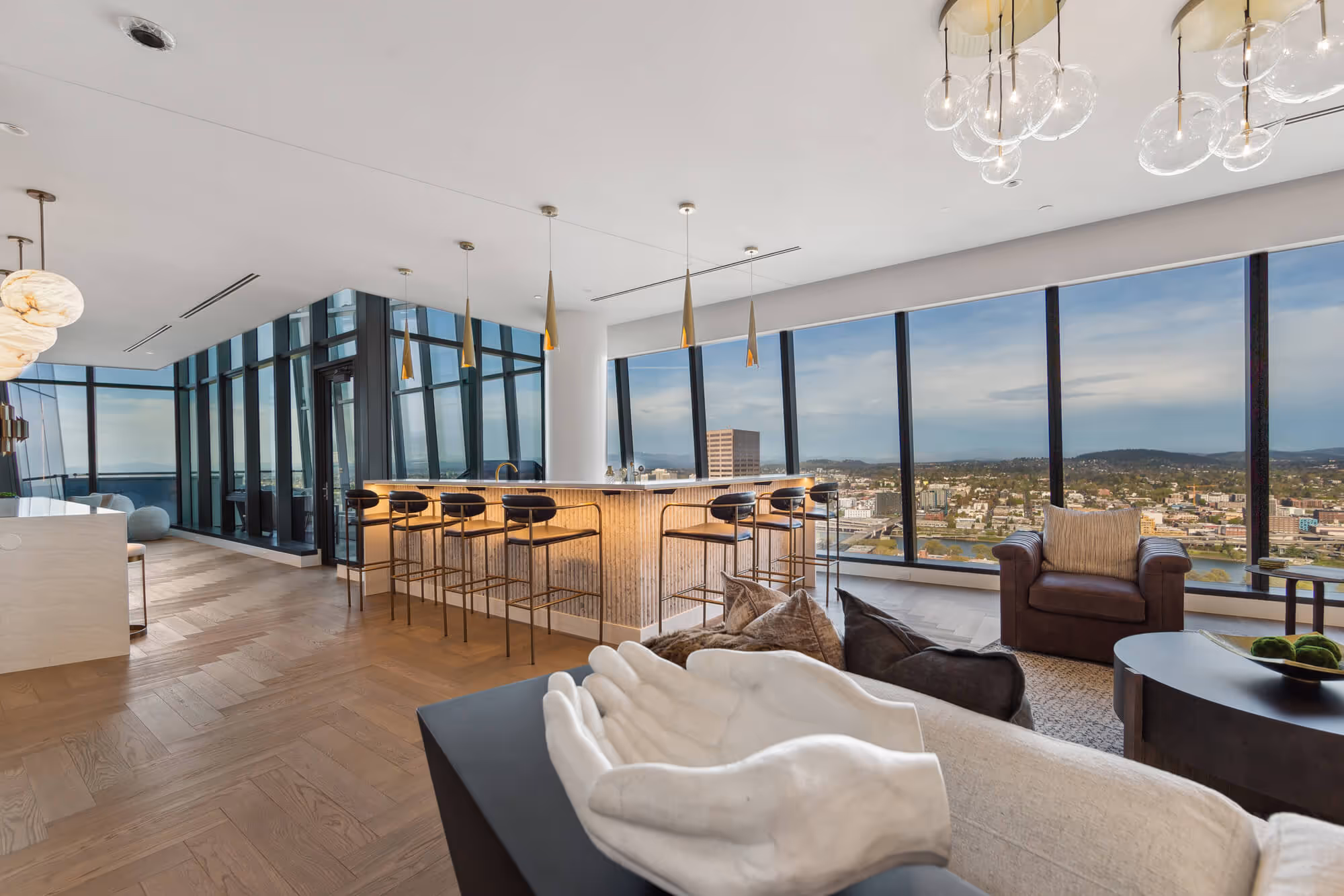 Living space of a Penthouse with expansive views through window walls.