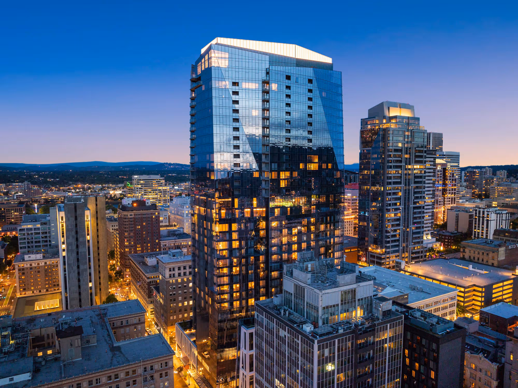 The Ritz-Carlton Residences, Portland stands proudly in the Portland skyline at dusk