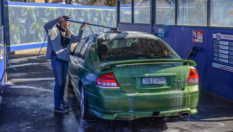 Man brushing the car