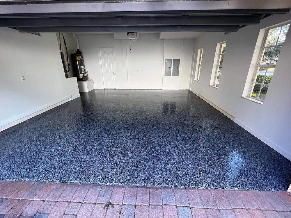 garage with white walls and blue epoxy floor.