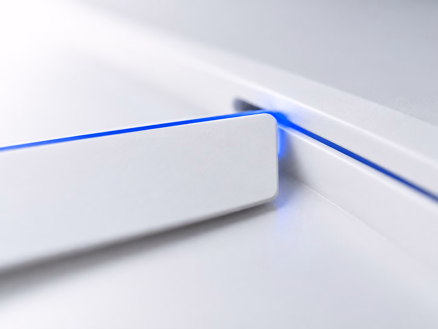 A blank white card sliding into a slot, traced by a thin blue line
