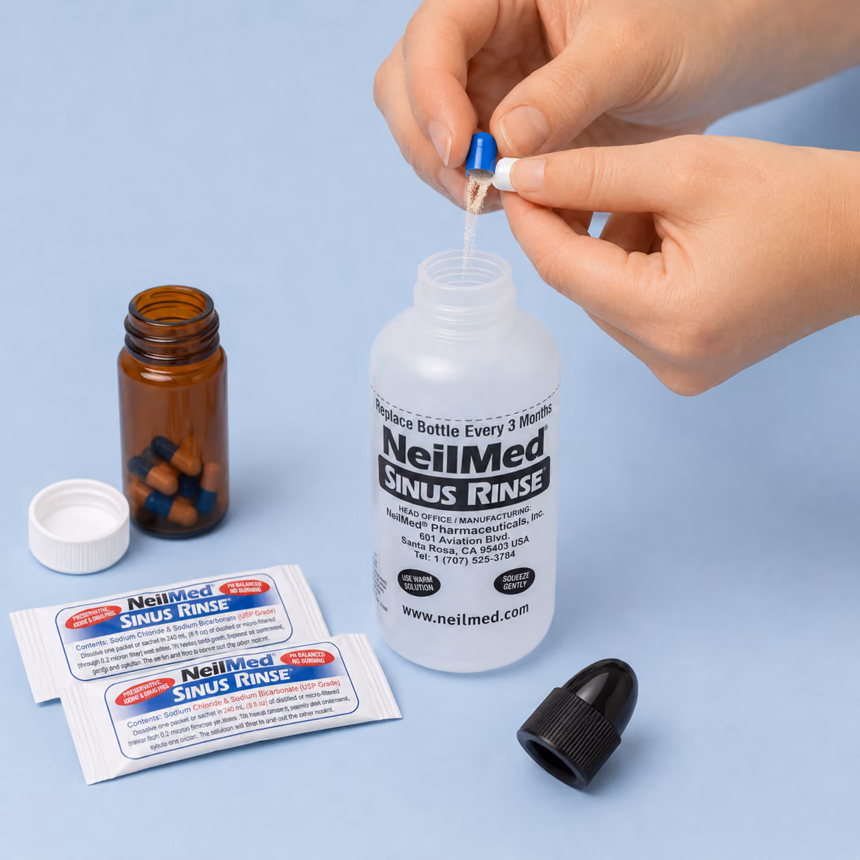 Budesonide capsule being emptied into a saline sinus rinse bottle
