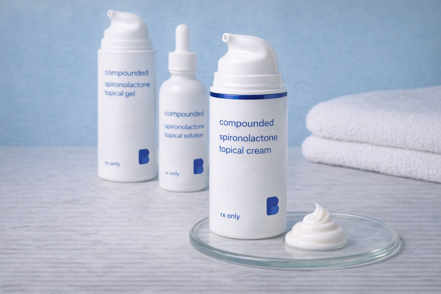 A swirl of compounded spironolactone topical cream on a glass dish beside its pump, with the gel and solution behind