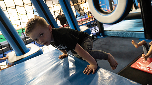 A young boy on an obstacle course at Auburn Gymnastics Center