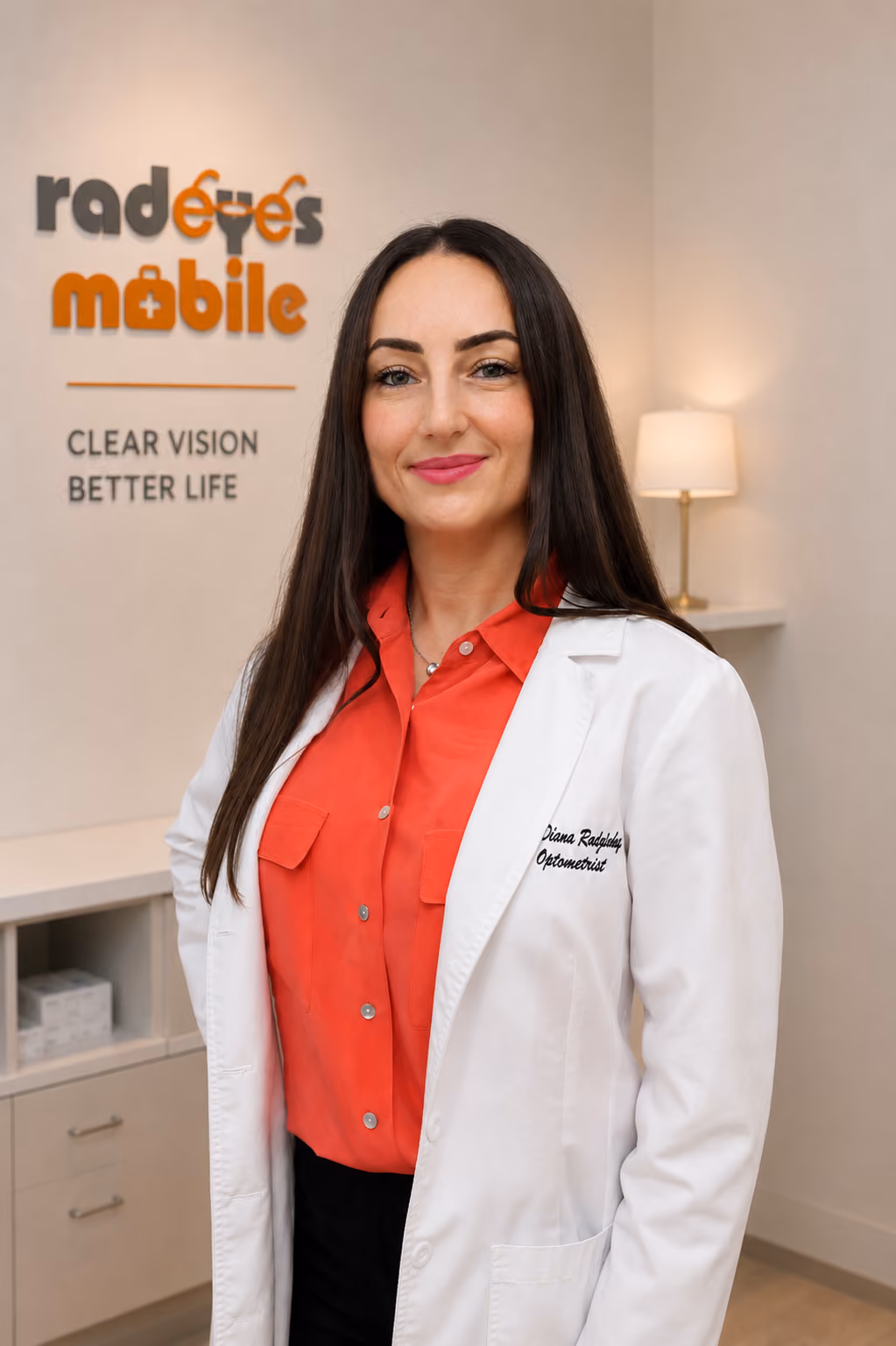 Optometrist in a white coat standing in a Rad Eyes Mobile eye care clinic.