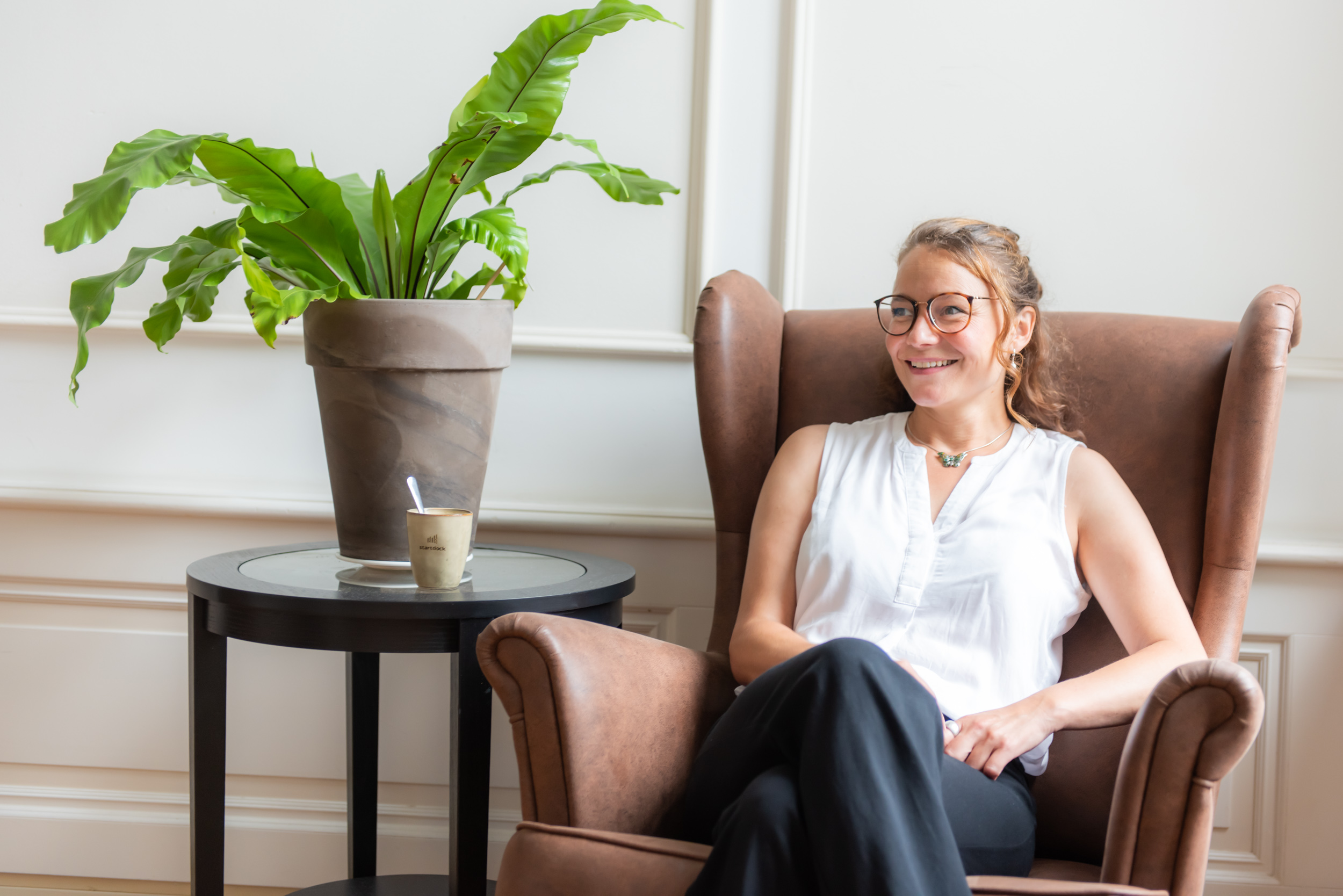 Woman sitting on couch smiling