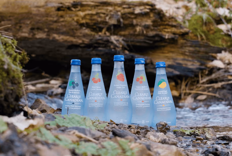 Clearly Canadian bottles in all different flavours in a creek.