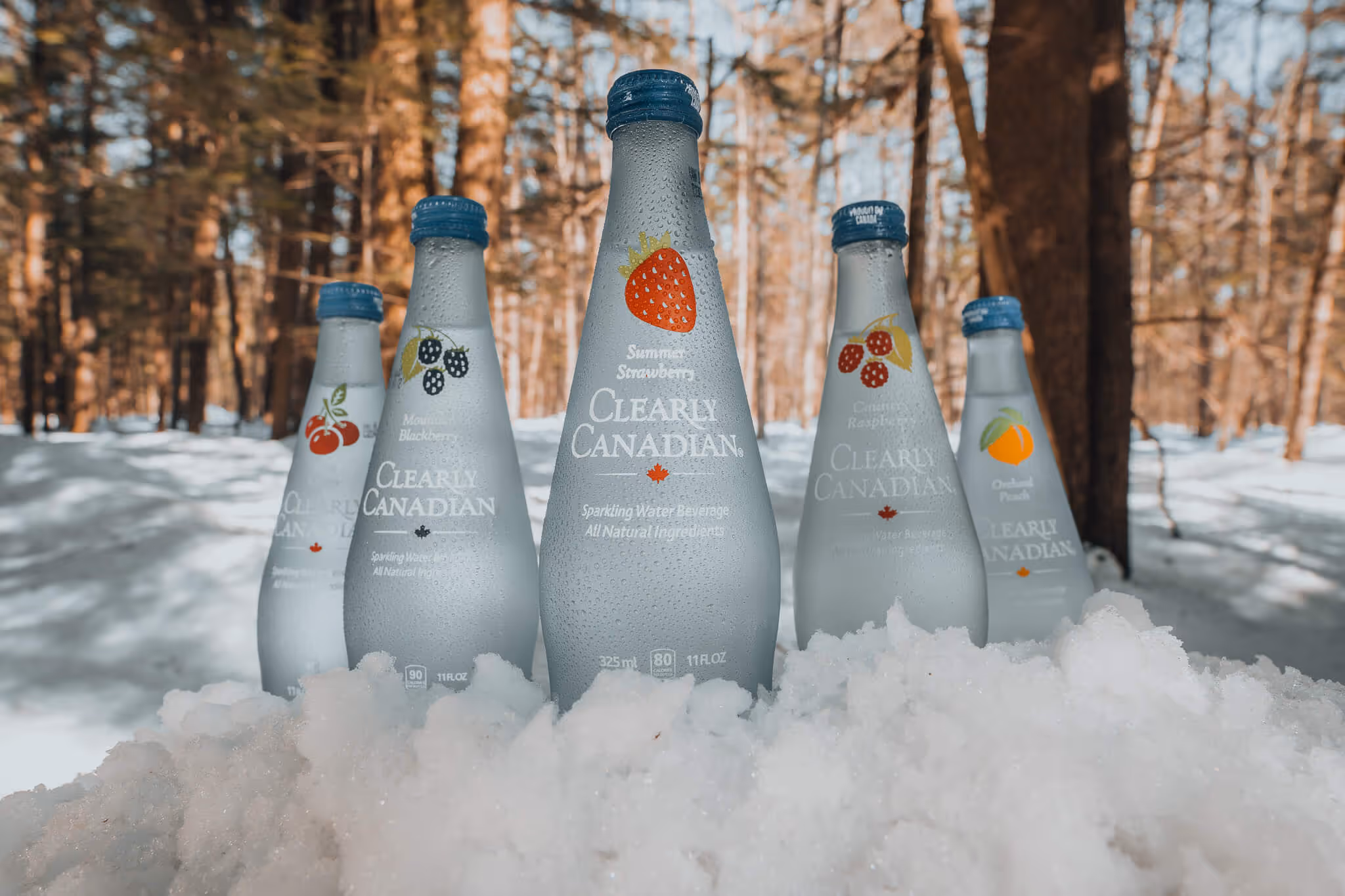 A close up of condensation dripping on Clearly Canadian bottles.