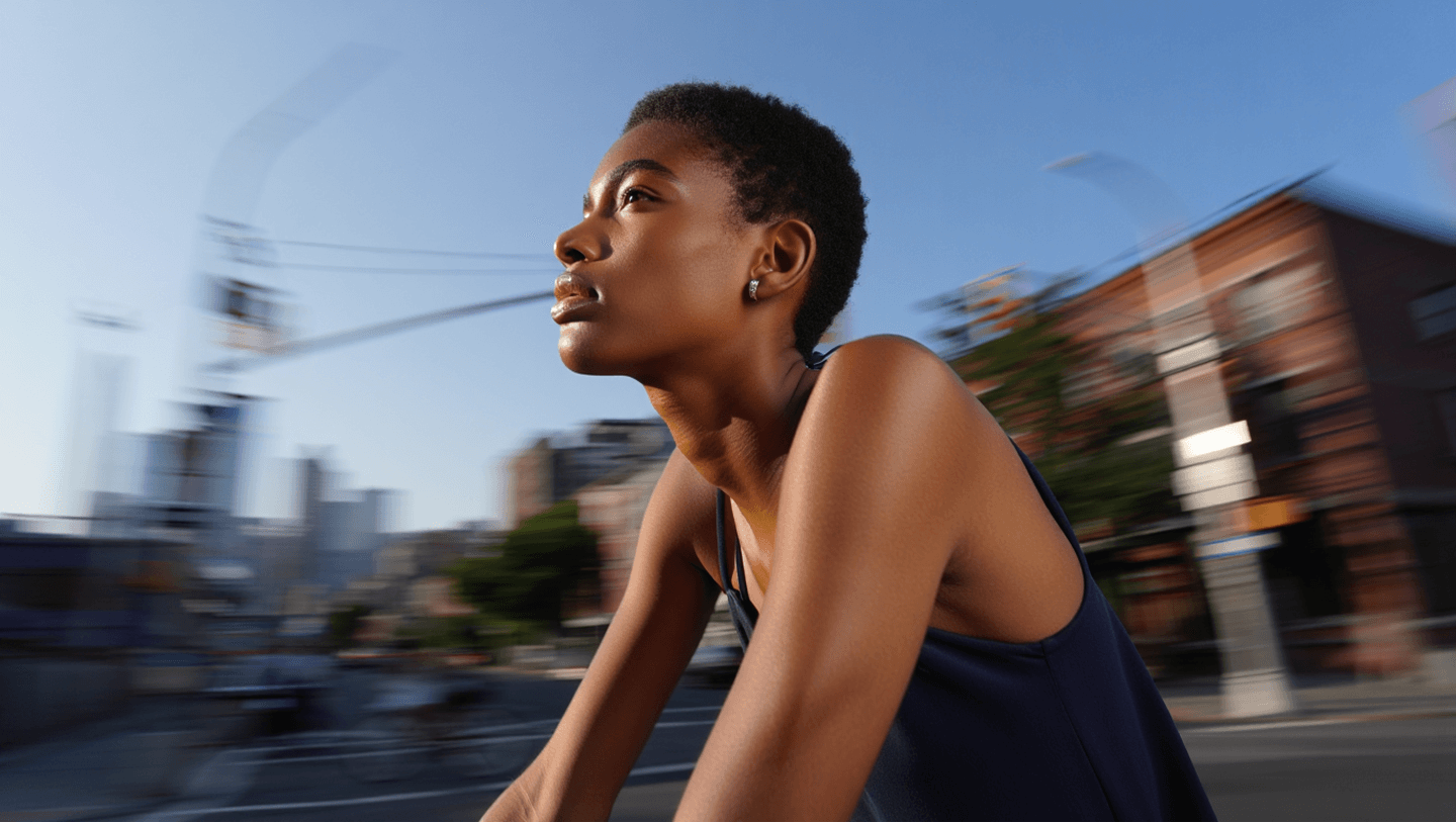 a young black woman riding Rybit bike in the city