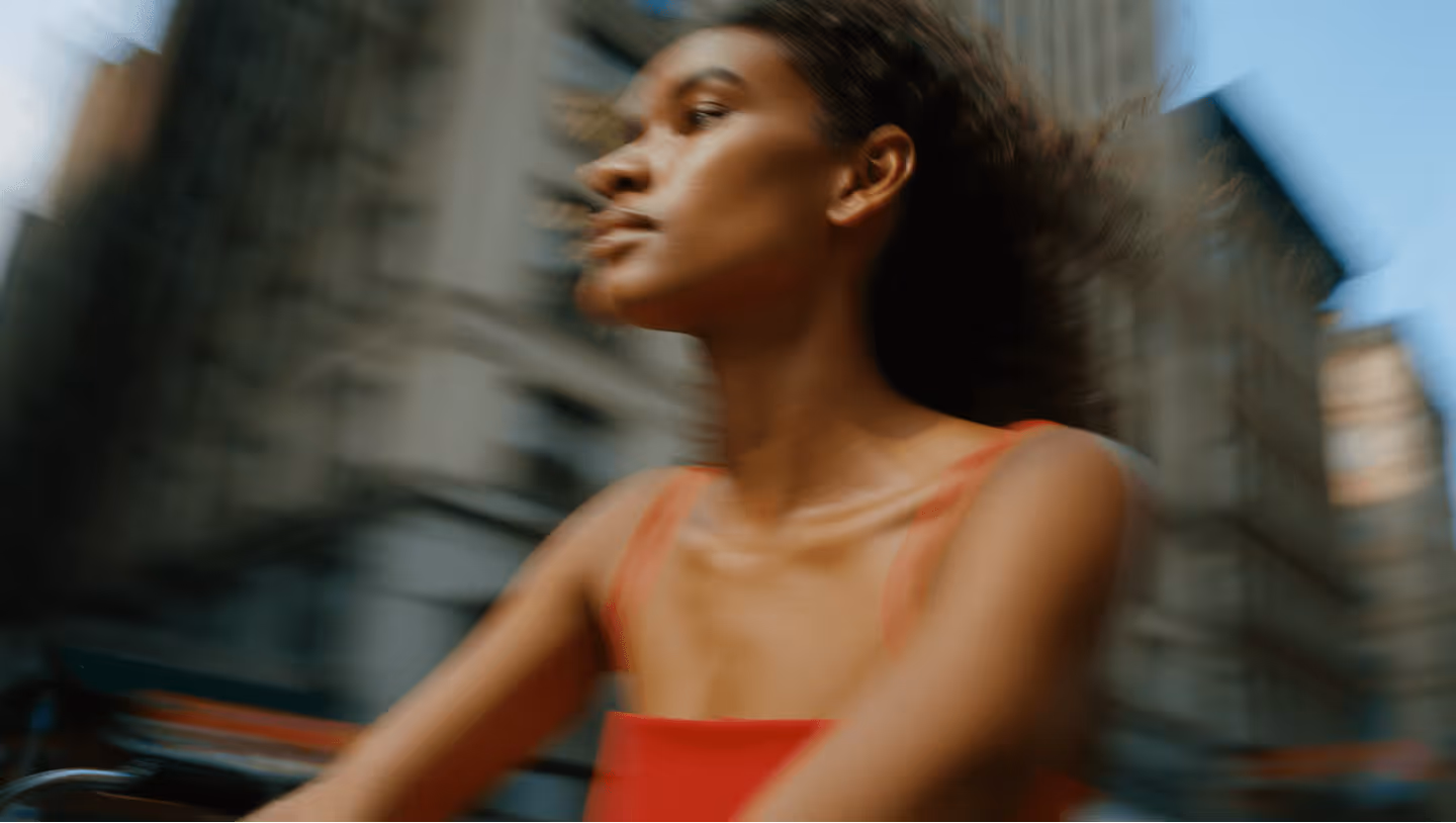 a black woman riding Rybit bike in the city