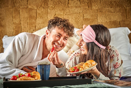 Couple enjoying breakfast in bed