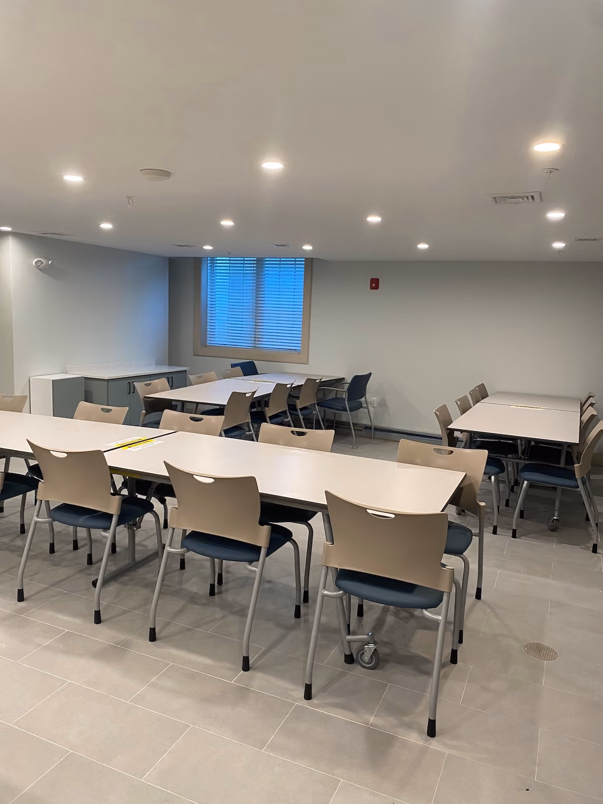 Residential treatment facility dining area with multiple tables and chairs, ideal for communal meals and group activities