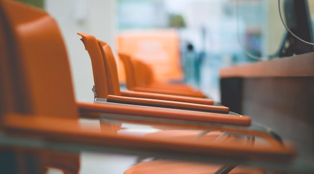 Close up of orange leather arm chairs in a conference room in an office designed by Office Gallery International
