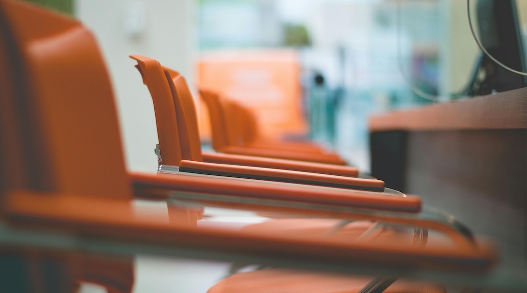 Close up of orange leather arm chairs in a conference room in an office designed by Office Gallery International