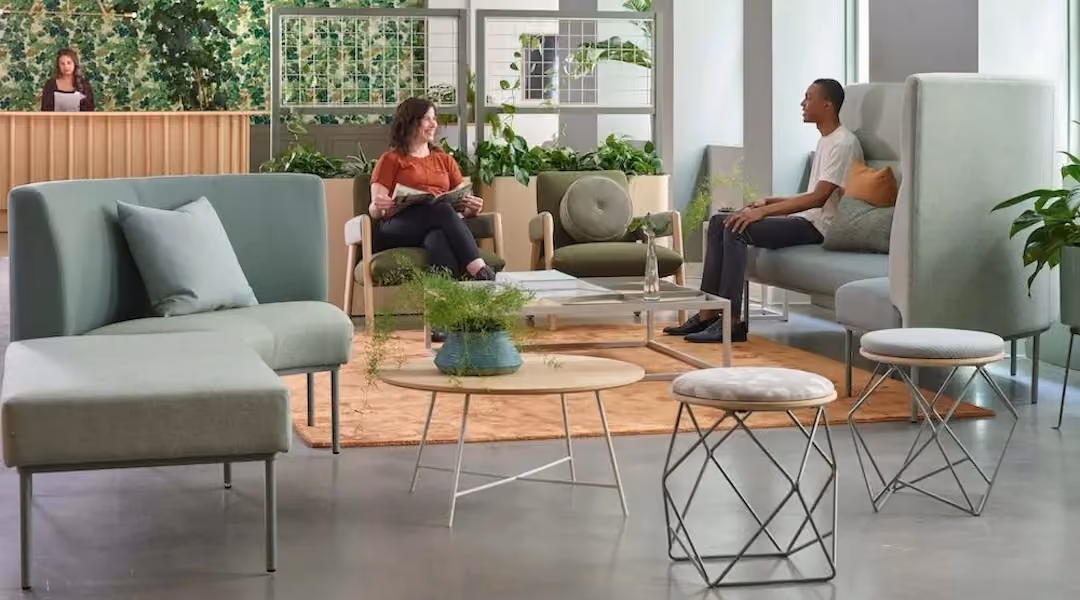 Man and woman sitting and interacting in an office lounge Directly labeled "Collaborative Seating" on OGI's own seating product page — two people engaged in conversation in a lounge setting. Couldn't be more on-the-nose for this article.