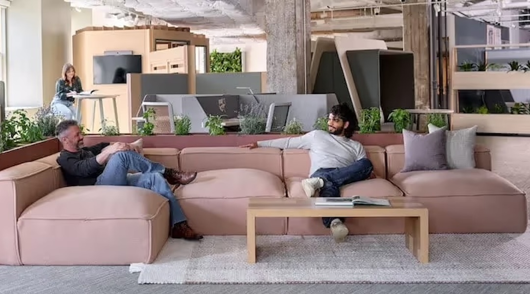 Two professionals relaxing on reception area sofas — commercial seating solutions for Boston-area businesses from Office Gallery International