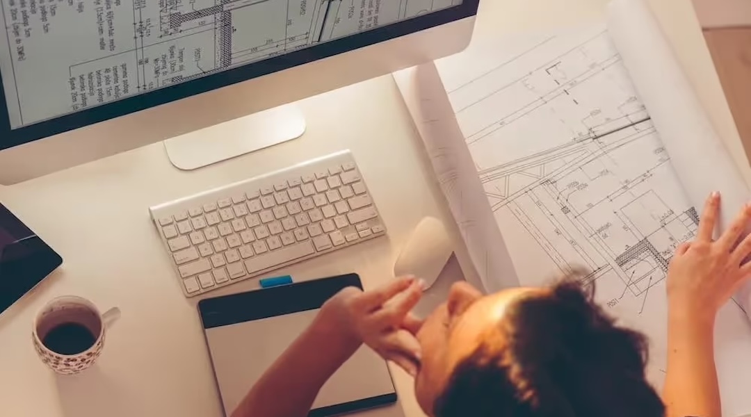 Office design professional reviewing workspace plans — custom ergonomic furniture consultation services from Office Gallery International in Boston
