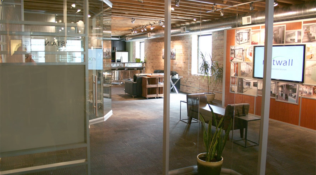 NxtWall demountable glass wall system installed in a professional office environment — available through Office Gallery for Boston-area businesses seeking flexible workspace solutions