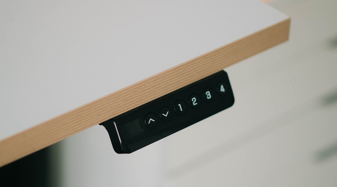 Close-up of a modern adjustable height desk with integrated control panel for height adjustment available at Office Gallery International.