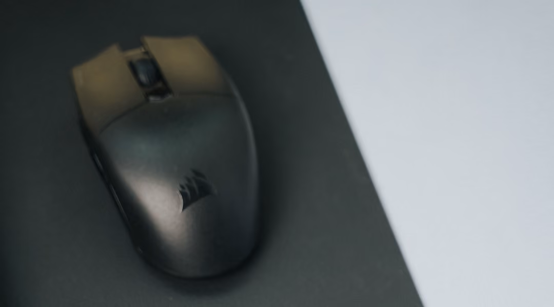 Close-up of a modern office desk with a mouse and pad, highlighting minimalistic design.