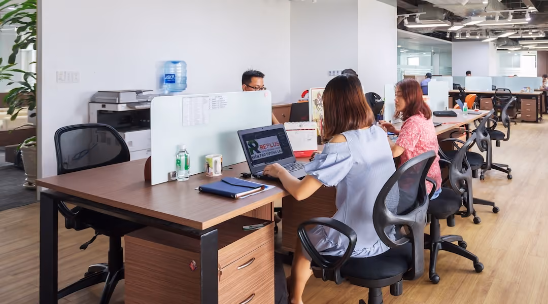 Spacious modern office in Vietnam with employees collaborating at desks.