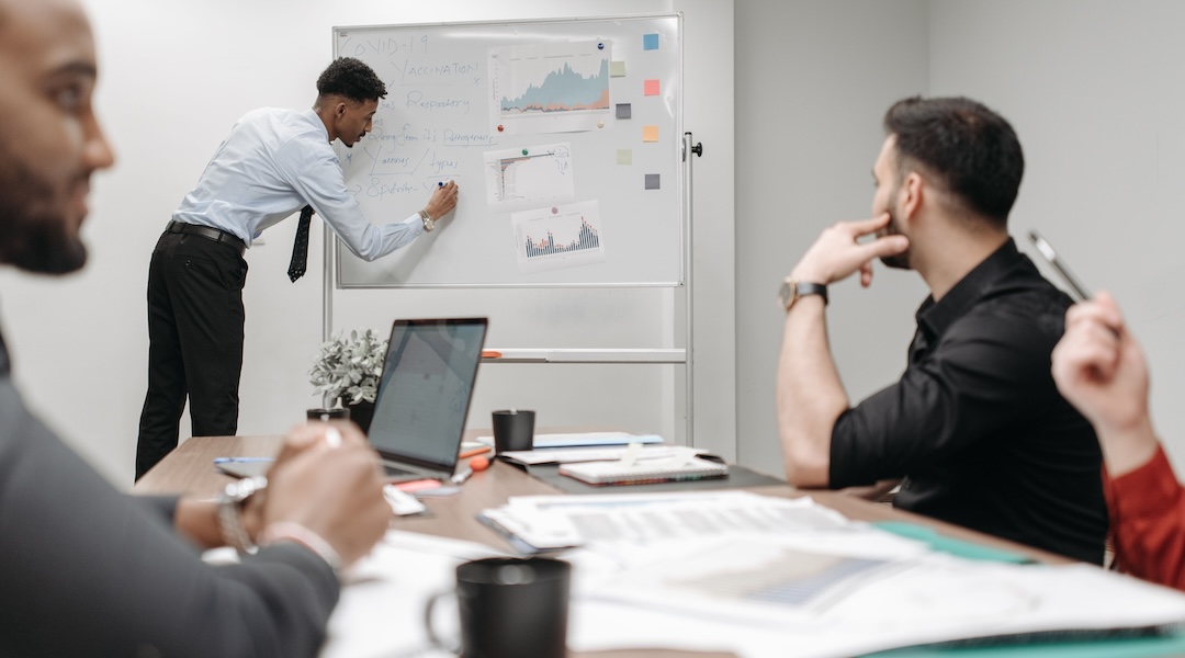 Colleagues in a business meeting discussing data and strategies at the office.