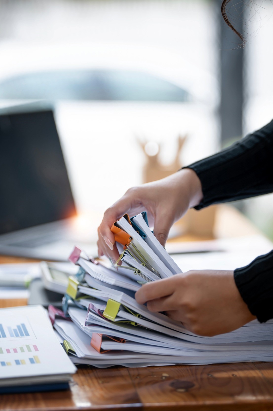 Someone sorting through a large stack of paperwork, likely for organizing or processing. If this is related to veterans' paperwork, it's possible that the documents involve applications for benefits, medical records, or service-related claims. Organizing these types of forms can be quite intricate, as they often require attention to detail and specific documentation.