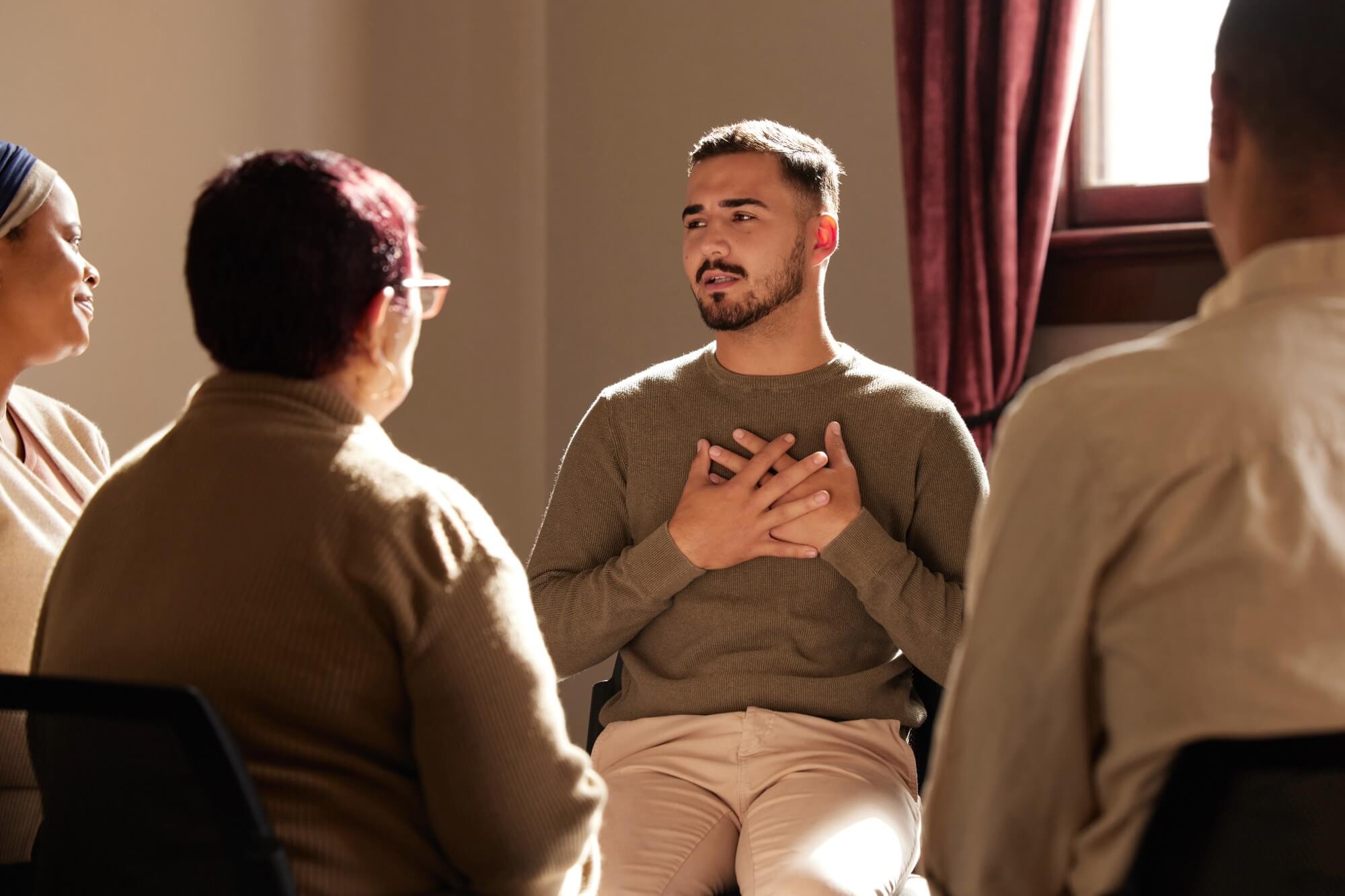 People in group therapy session sitting in a circle.