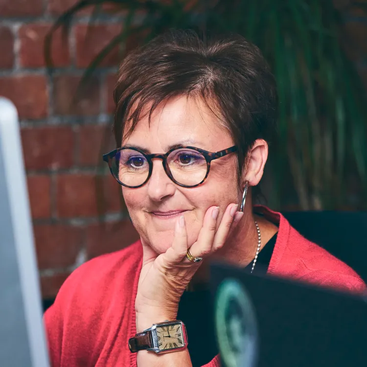 Helen from The Brady Creative working on a desktop.