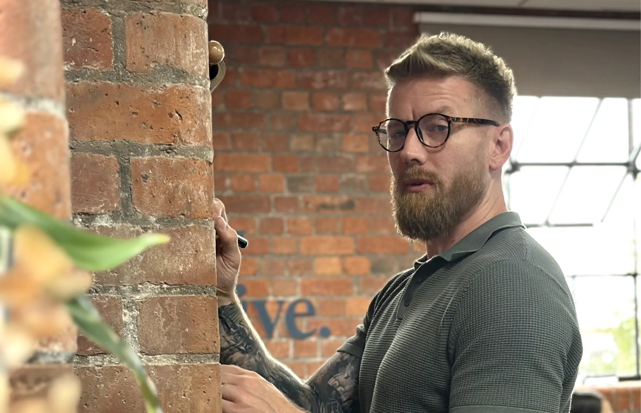 Paul from The Brady Creative writing on a mystery white board.
