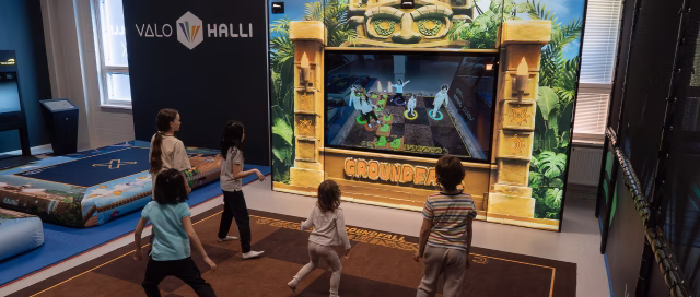 Five kids playing Groundfall in an active entertainment venue.