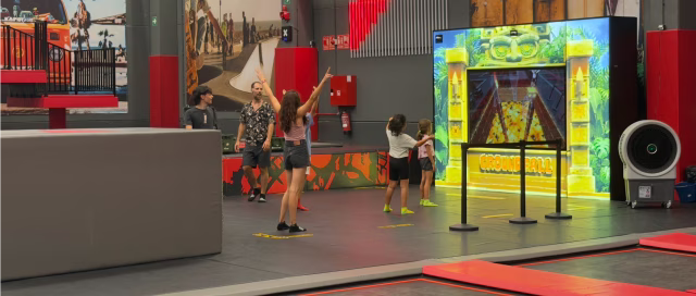 Five kids playing Groundfall in an active entertainment venue.