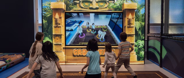 Five kids playing Groundfall in an active entertainment venue.