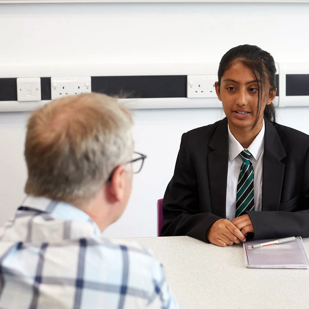 A Diana Award volunteer speaking to a School student