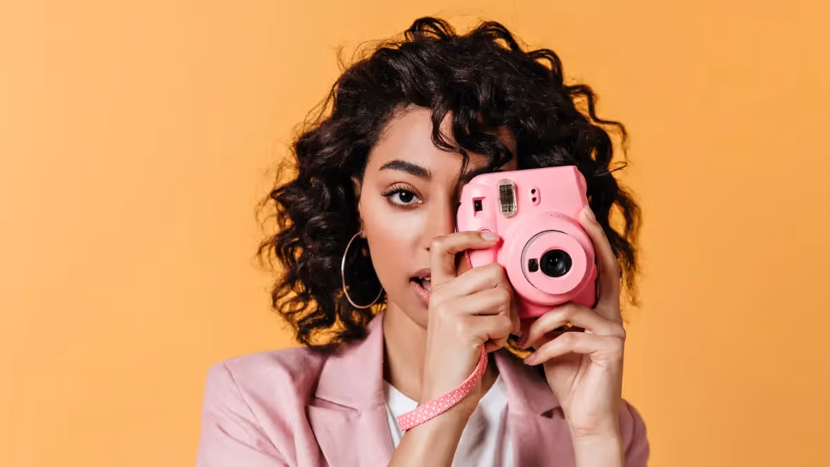 A women influencr holding a camera for creative concepting