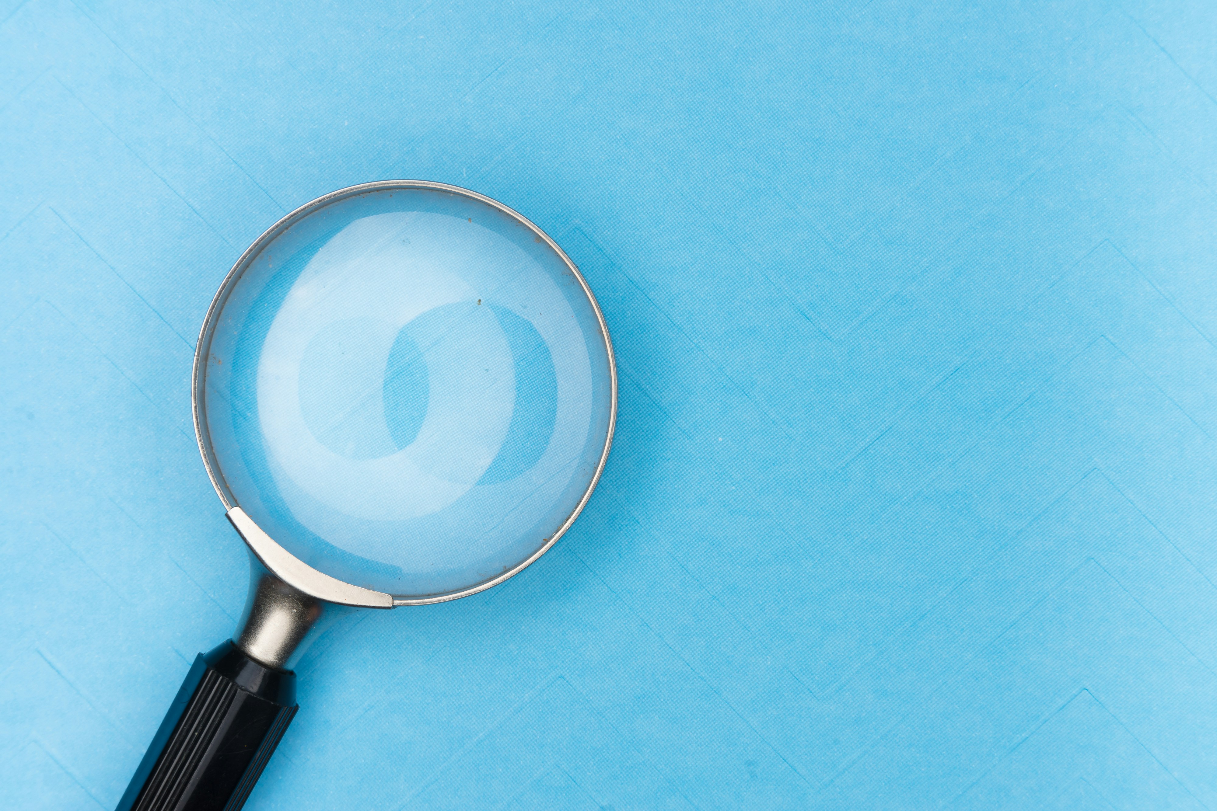 magnifying glass with blue background
