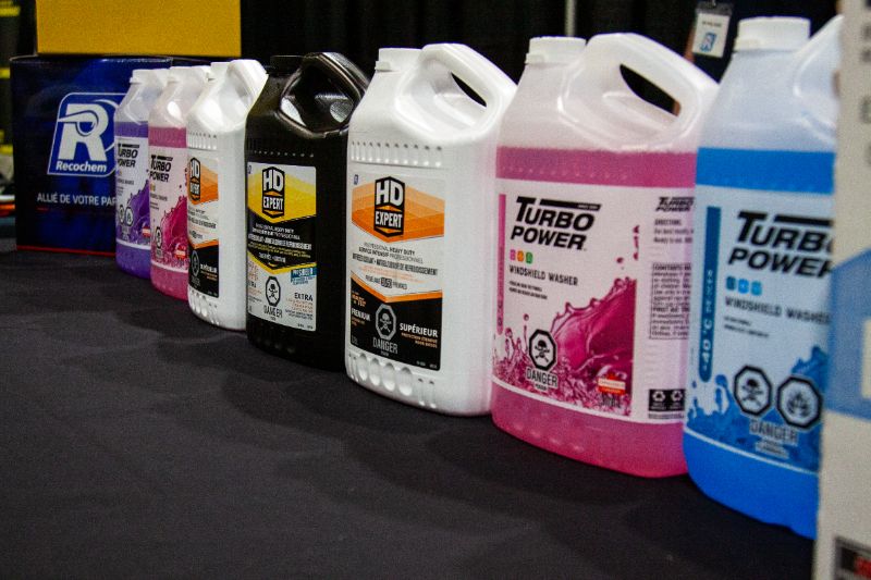 Turbo Power windshield washer fluid jugs lined up for heavy-duty truck repair shop supplies.