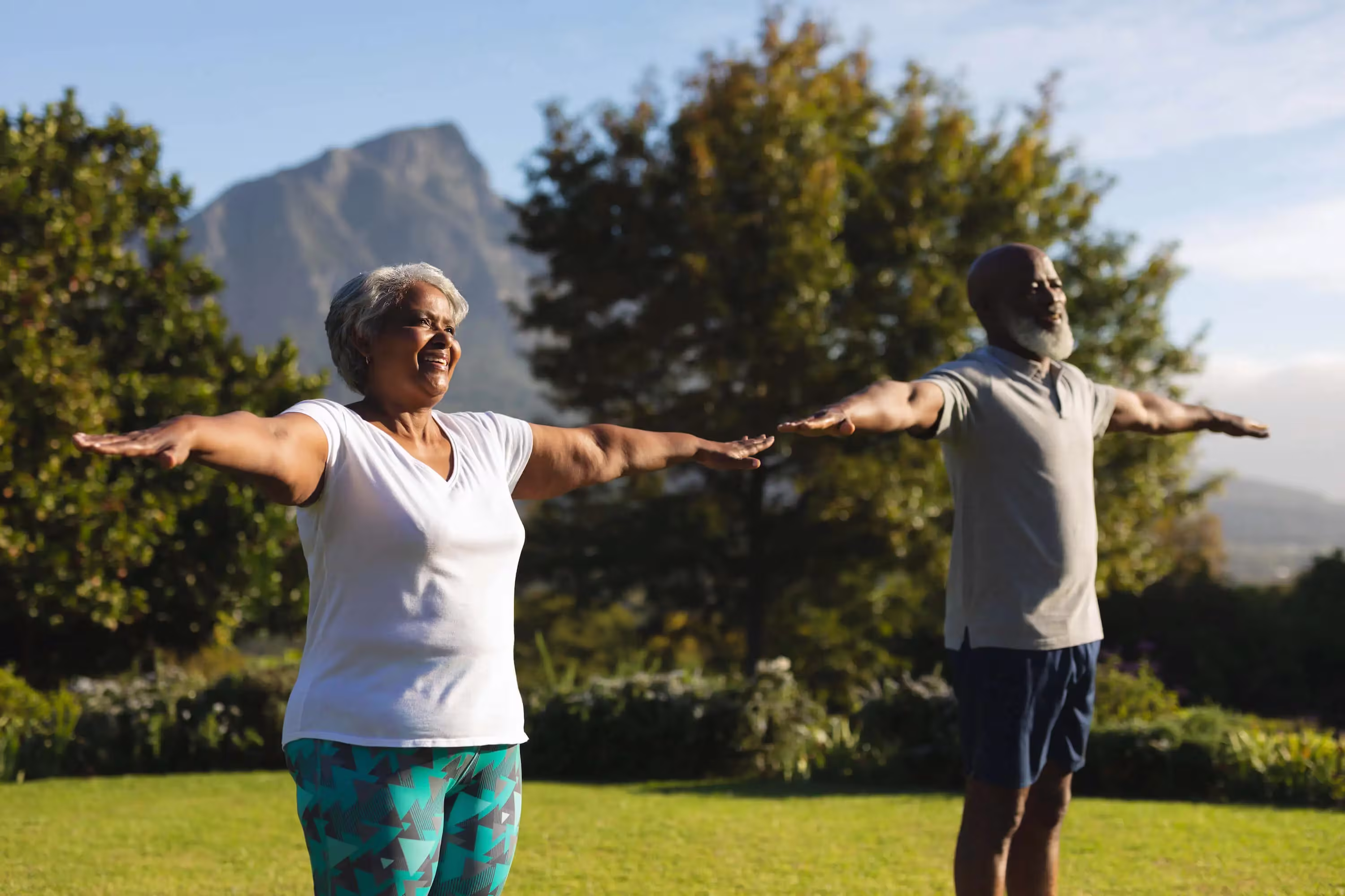 older african american couple doing exercises outside