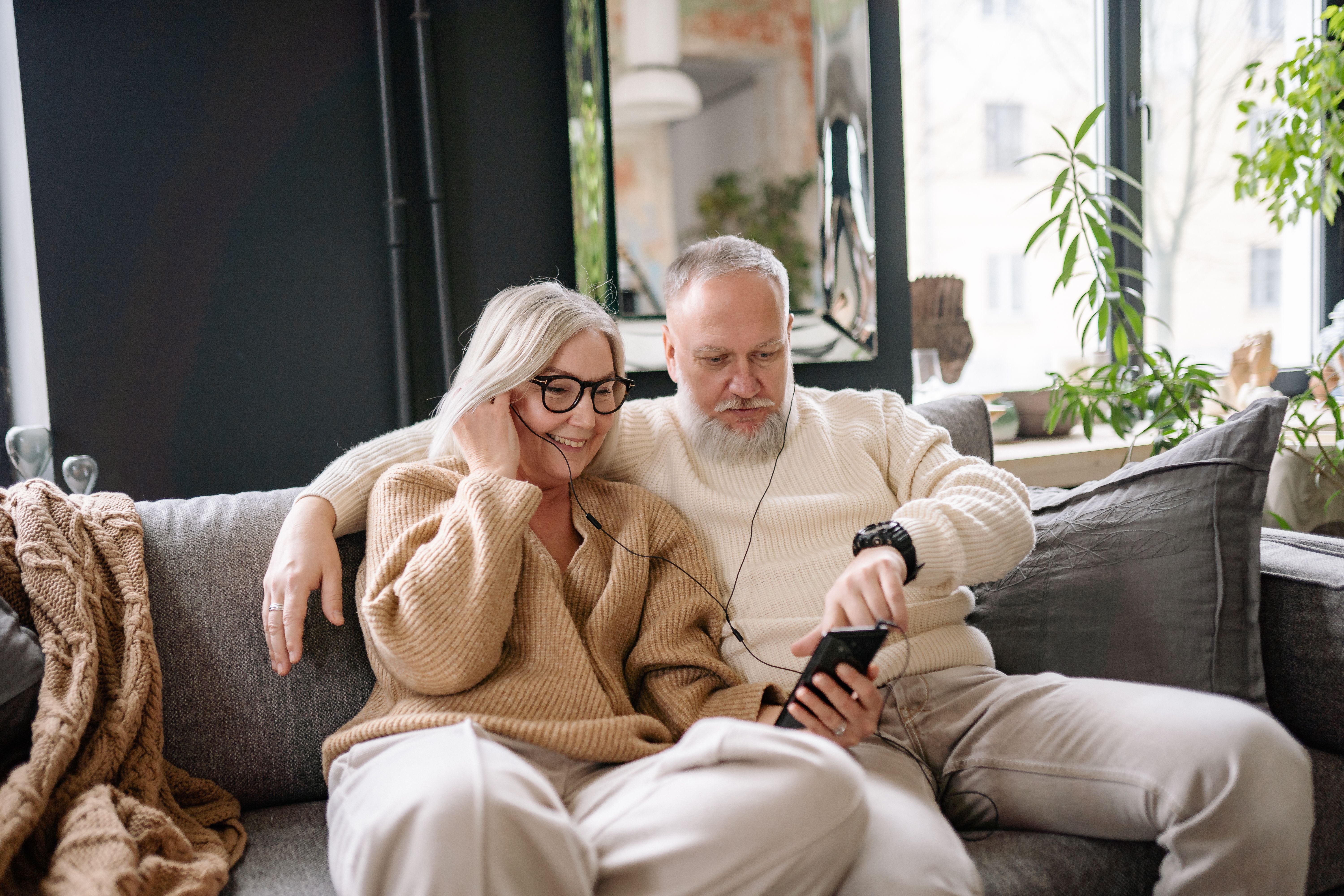 elderly couple enjoying their favorite music playlist