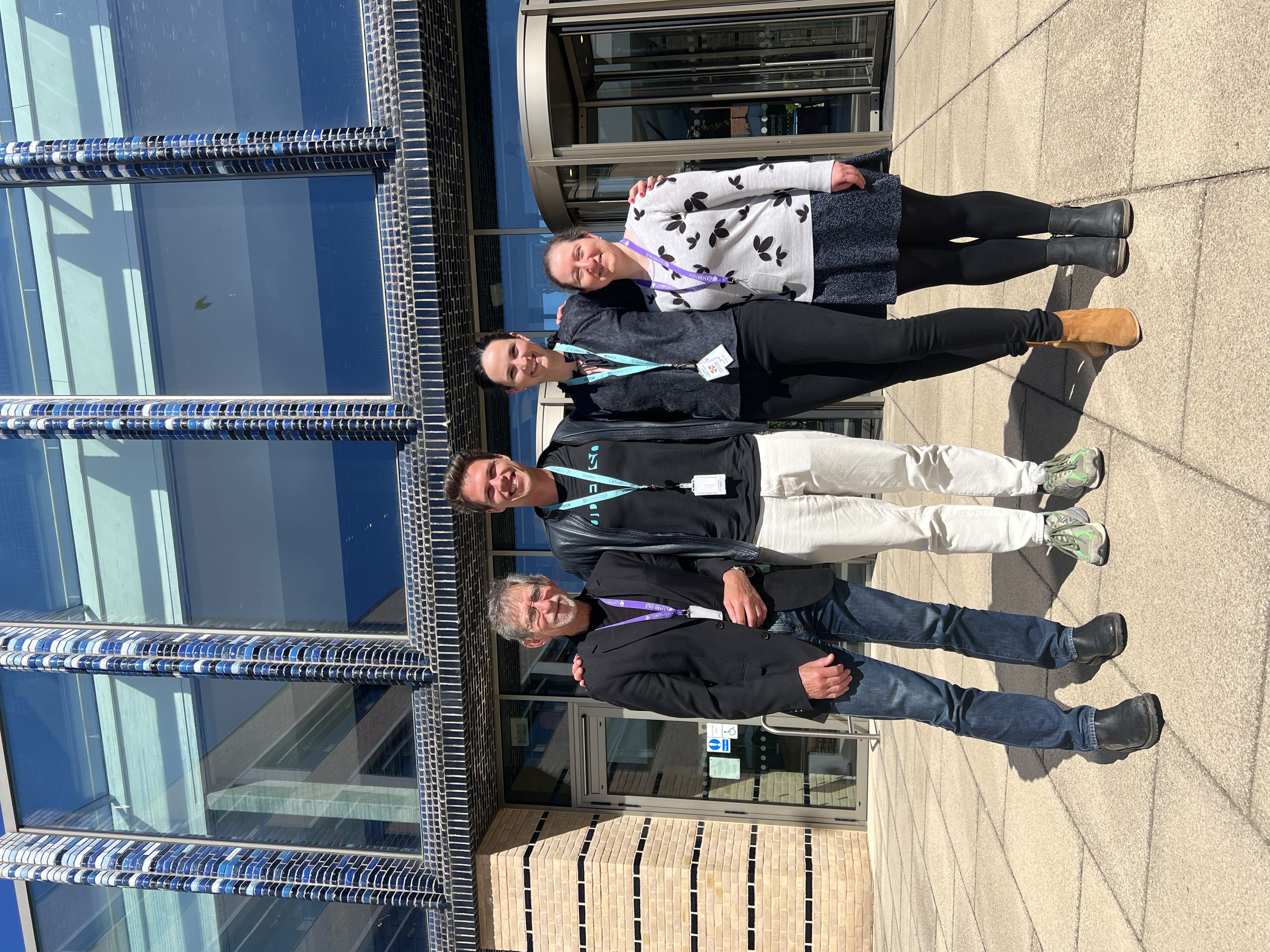 A photo of Tim Oates, Eirik Wahlstrøm, Ingrid Skrede and Sylvia Vitello in front of Cambridge University Press and Assessment's HQ