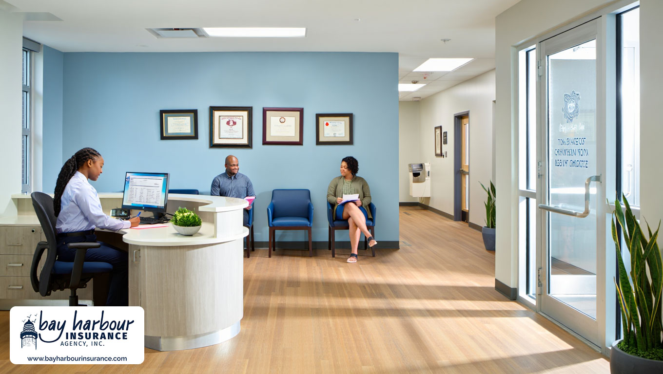 modern medical office waiting room in Long Island, NY features a receptionist in business attire seated behind a curved white desk with a computer monitor - business professional liability insurance long island concept