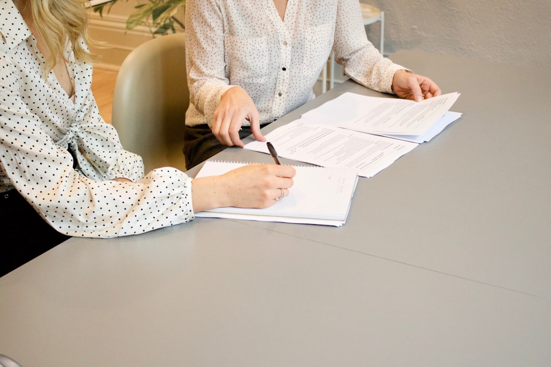 A homeowner and an insurance agent reviewing documents at a table, with a calm and reassuring atmosphere - vacant home insurance