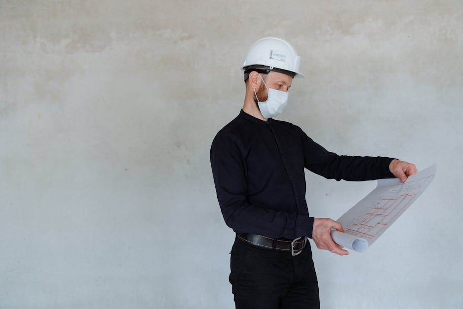 A construction worker reviewing blueprints for a home in Medford, NY - calculating home insurance A construction worker reviewing blueprints for a home in Medford, NY - calculating home insurance