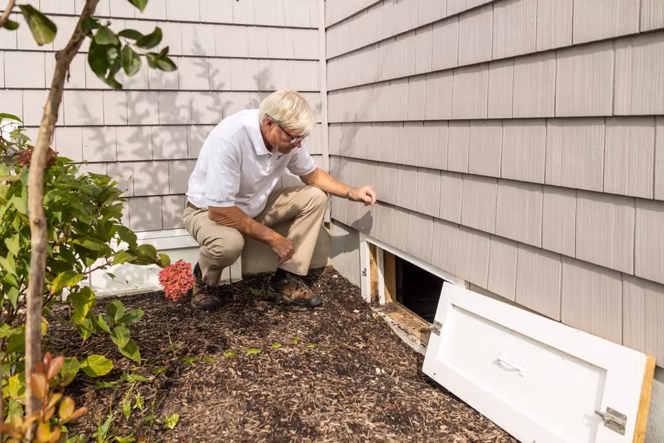 Home inspector checking a Medford basement with a flashlight Home inspector checking a Medford basement with a flashlight