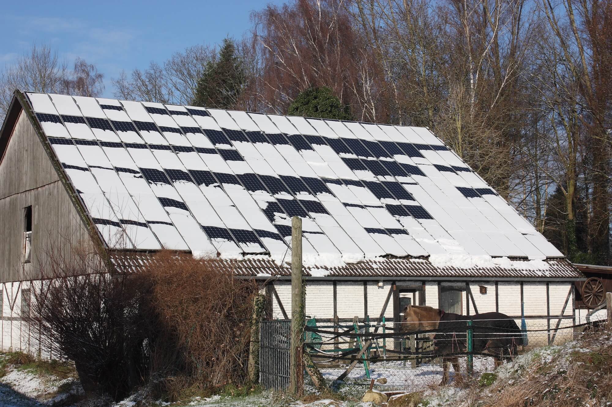 Komplett eingeschneite PV-Module auf einem alten Haus