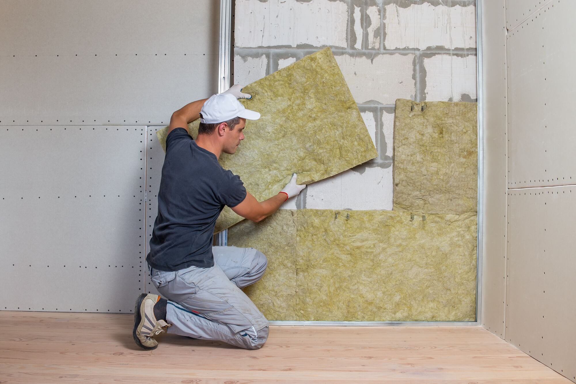 Handwerker dämmt eine Wand